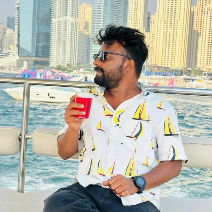 Harshad relaxing on a boat deck with the Dubai skyline behind