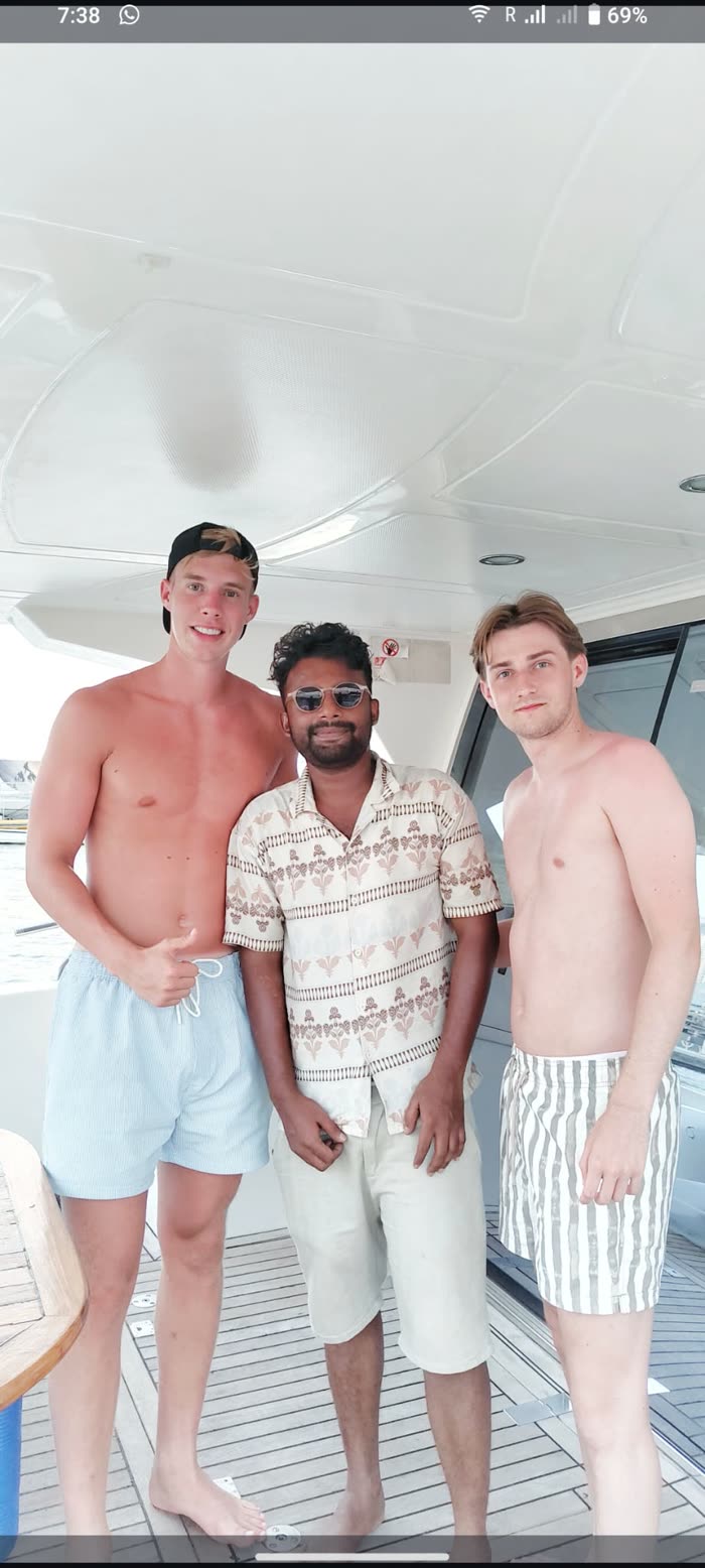 Harshad on a yacht deck with two guests
