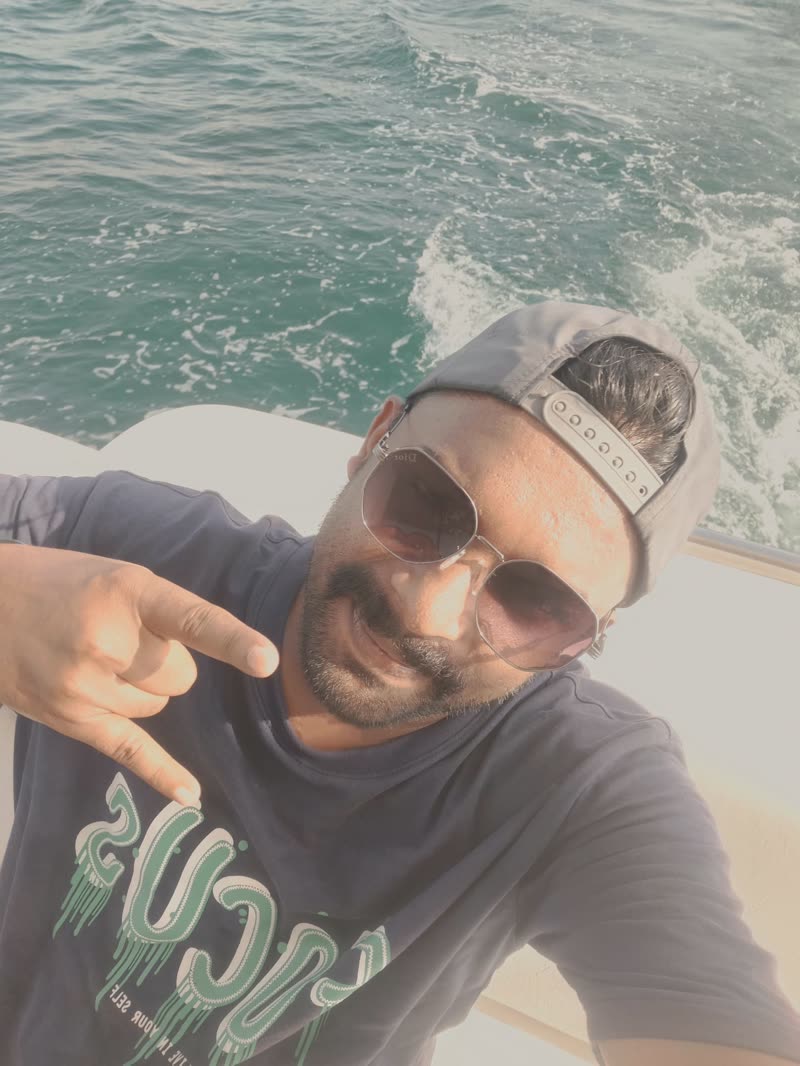 Harshad smiling in a selfie at the back of a moving boat
